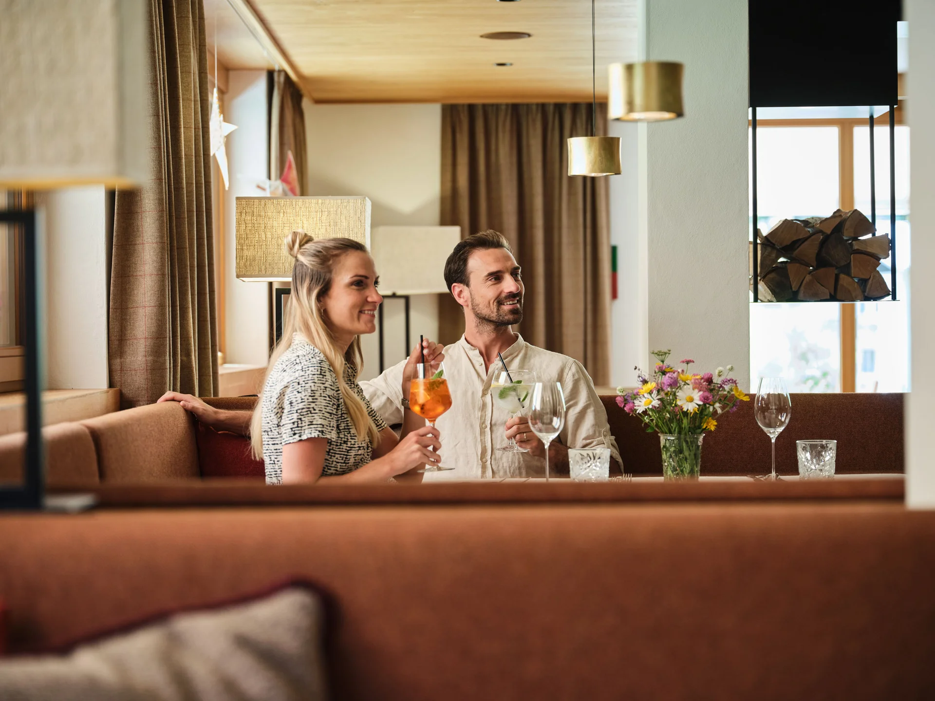 Paar sitzt im Restaurant und genießt Getränke mit lächelnden Gesichtern.